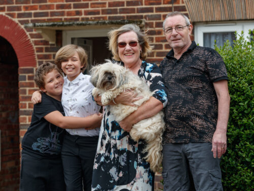 Janice and her family, who have moved into a Greatwell Homes property, smiling at the camera.