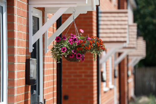 Picture of a flower basket outside some houses