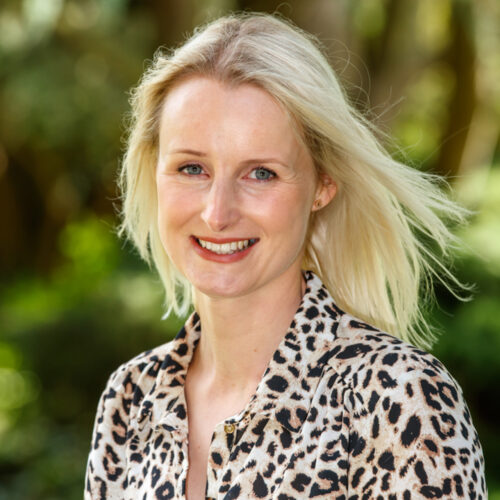 Headshot of Kayleigh, Income Recovery Officer, smiling at the camera.