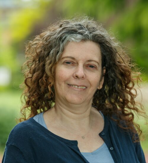 Headshot of Lucy, Income Recovery Officer, smiling at the camera.